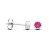Sterling silver stud earrings with faceted simulated rubies in bezel settings, shown from the side and front.