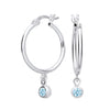 Silver hoop earrings with simulated aquamarine charms, representing the March birthstone, dangle from each earring.