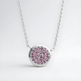 Sterling silver necklace with a circle cluster pendant set with simulated rubies in a polished design.