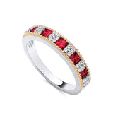 Sterling silver eternity ring with square red stones, CZ clusters, and gold beaded edges.