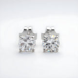 Silversmiths Sterling Silver stud earrings with 4mm round cubic zirconia and butterfly backs on a white background.