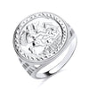 This sterling silver ring by Silversmiths has a round engraved St George face and detailed geometric edges.