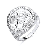 This sterling silver ring by Silversmiths has a round engraved St George face and detailed geometric edges.
