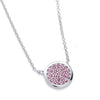 Sterling silver necklace with a circle cluster pendant featuring simulated rubies and sparkling gemstones.