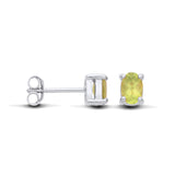 Sterling silver oval stud earrings by Silversmiths with natural peridot, shown from front and side views.
