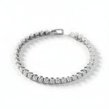 A Silversmiths sterling silver tennis bracelet with cubic zirconia clusters is displayed against a white background.