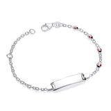 Sterling silver children’s ID bracelet with multiple ladybird designs, featuring red and black accents on a white plate.