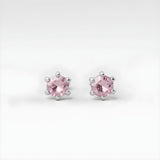 Silversmiths sterling silver stud earrings feature pink topaz stones in six-prong settings.