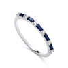 Sterling silver eternity band ring featuring simulated sapphires and cubic zirconia baguettes.