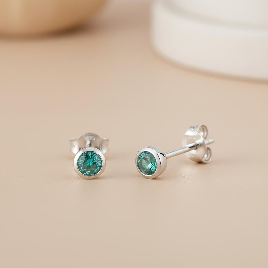 Silversmiths sterling silver stud earrings with 4mm simulated emerald stones in a simple green design.