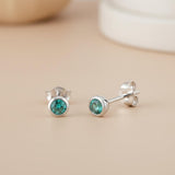 Silversmiths sterling silver stud earrings with 4mm simulated emerald stones in a simple green design.