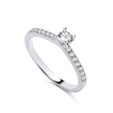 A sterling silver ring with cubic zirconia pavé shoulders lies against a plain white background.