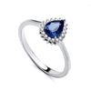 Sterling silver ring by Silversmiths featuring a pear-shaped simulated sapphire cluster and clear accent stones on the band.