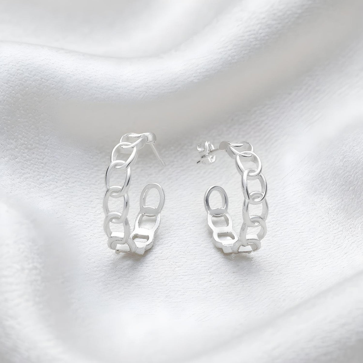 Silversmiths Sterling Silver 23mm chain link hoop earrings displayed on white fabric.