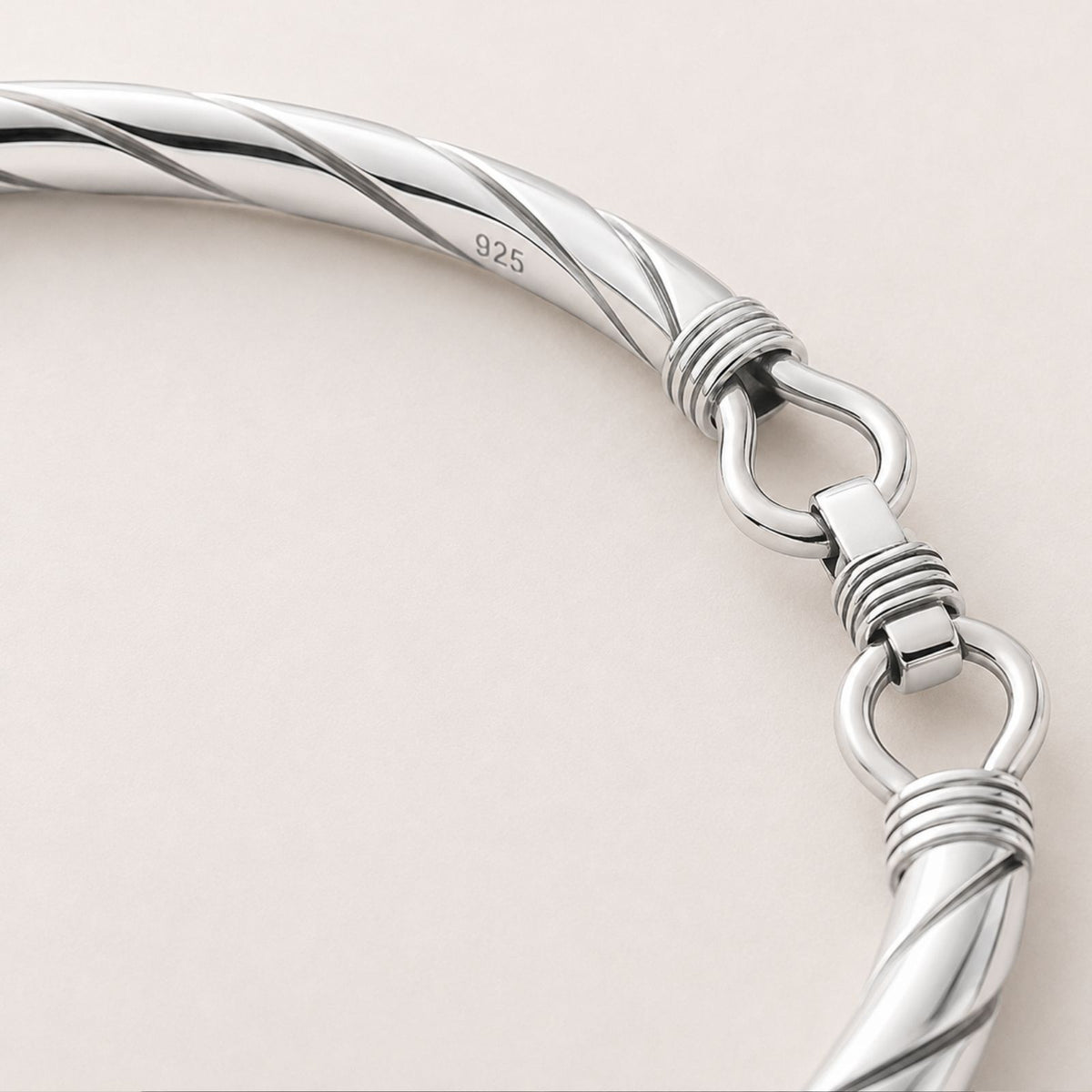 Twisted sterling silver 925 bracelet with a clasp shown close-up against a light background.