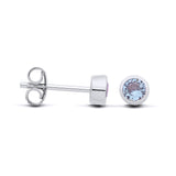 Silversmiths silver stud earrings with bezel-set simulated aquamarine stones and butterfly backings.