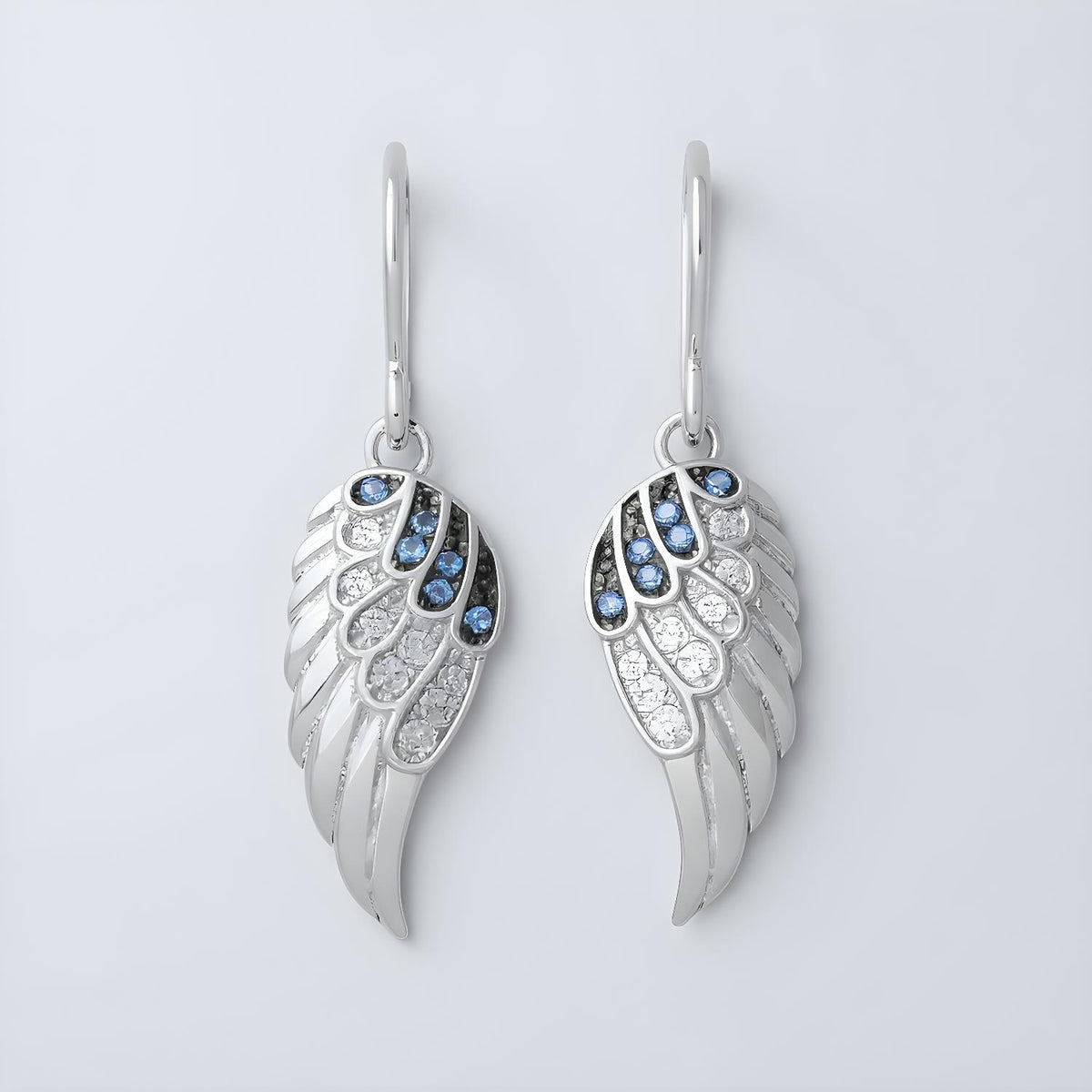 Sterling silver drop earrings with simulated sapphire stones and angel wing design by Silversmiths.