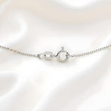 A sterling silver 1mm diamond cut rolo chain necklace with a spring ring clasp, displayed on white fabric.