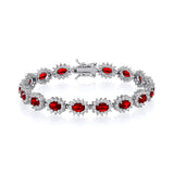 Sterling silver bracelet with simulated ruby oval halos and clear stones in a repeating pattern.