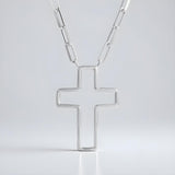 A Silversmiths sterling silver paperclip chain necklace with an open cross pendant on a plain white background.