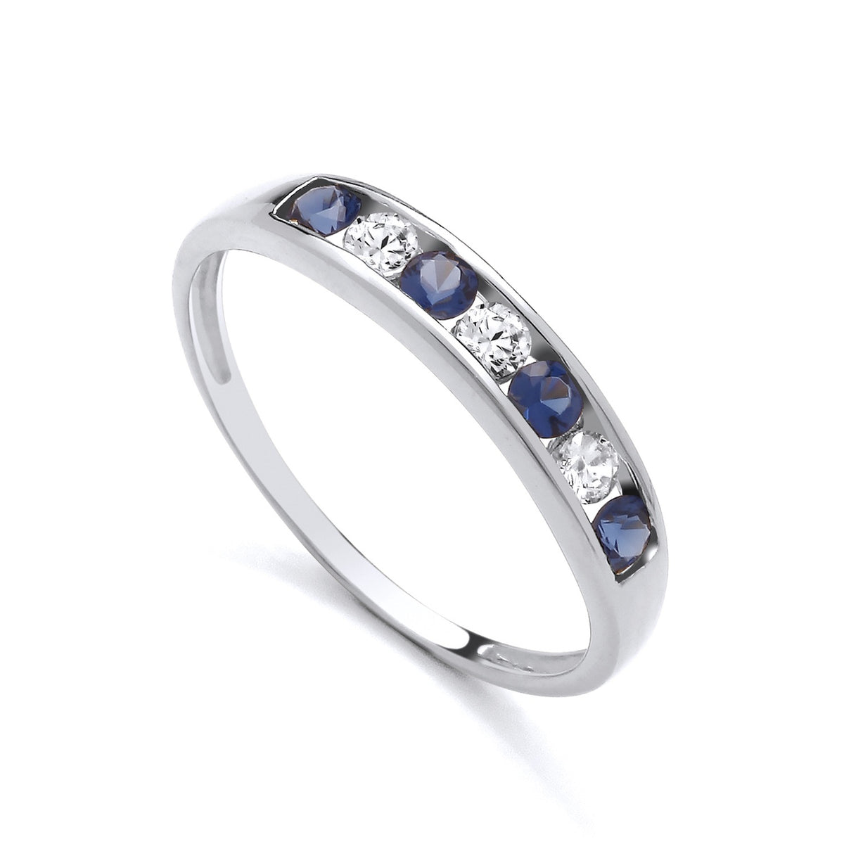 Sterling silver ring by Silversmiths featuring channel-set simulated sapphires and cubic zirconia in an eternity design.