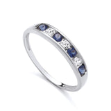 Sterling silver ring by Silversmiths featuring channel-set simulated sapphires and cubic zirconia in an eternity design.