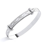 Sterling silver expanding baby bangle featuring a dolphin motif, shown on a smooth white background.