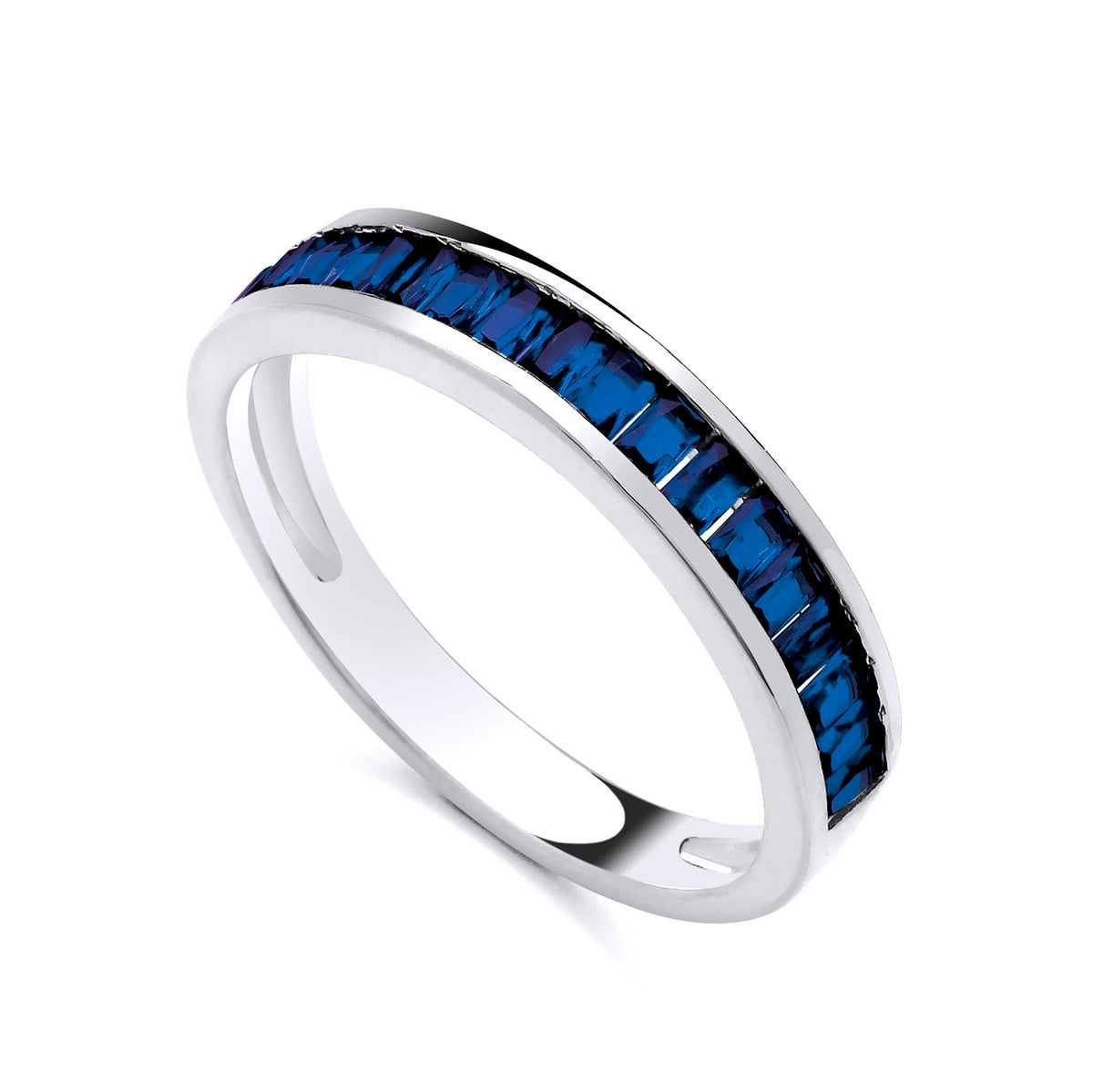 A Silversmiths sterling silver eternity ring with simulated sapphire baguettes, angled on a white background.