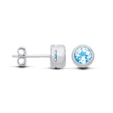 Sterling silver blue topaz stud earrings by Silversmiths shown from front and side views with bezel settings.