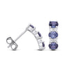 These sterling silver earrings have three simulated tanzanite stones in a vertical drop with sparkling accents.