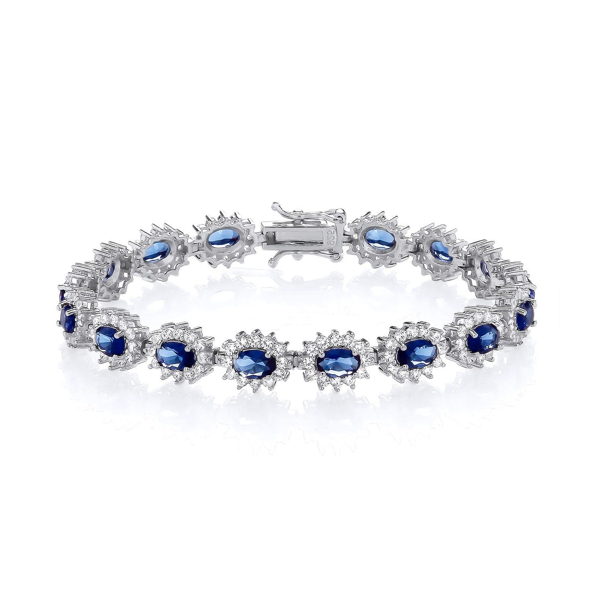 A sterling silver bracelet featuring oval simulated sapphires in a halo design is shown on a white background.