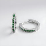 Sterling silver huggie hoops with a row of green simulated emerald stones, displayed against a white background.