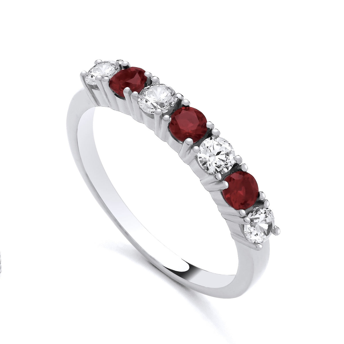 This sterling silver ring features three simulated rubies and four cubic zirconias in a half eternity design.