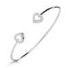 Sterling silver bangle by Silversmiths featuring cubic zirconia heart motifs in a simple, polished design.