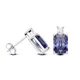 Sterling silver stud earrings with emerald-cut simulated tanzanite, displayed from front and side views.