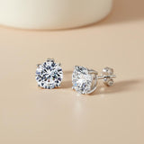 Silversmiths Sterling Silver 8mm round cubic zirconia stud earrings on a beige surface.