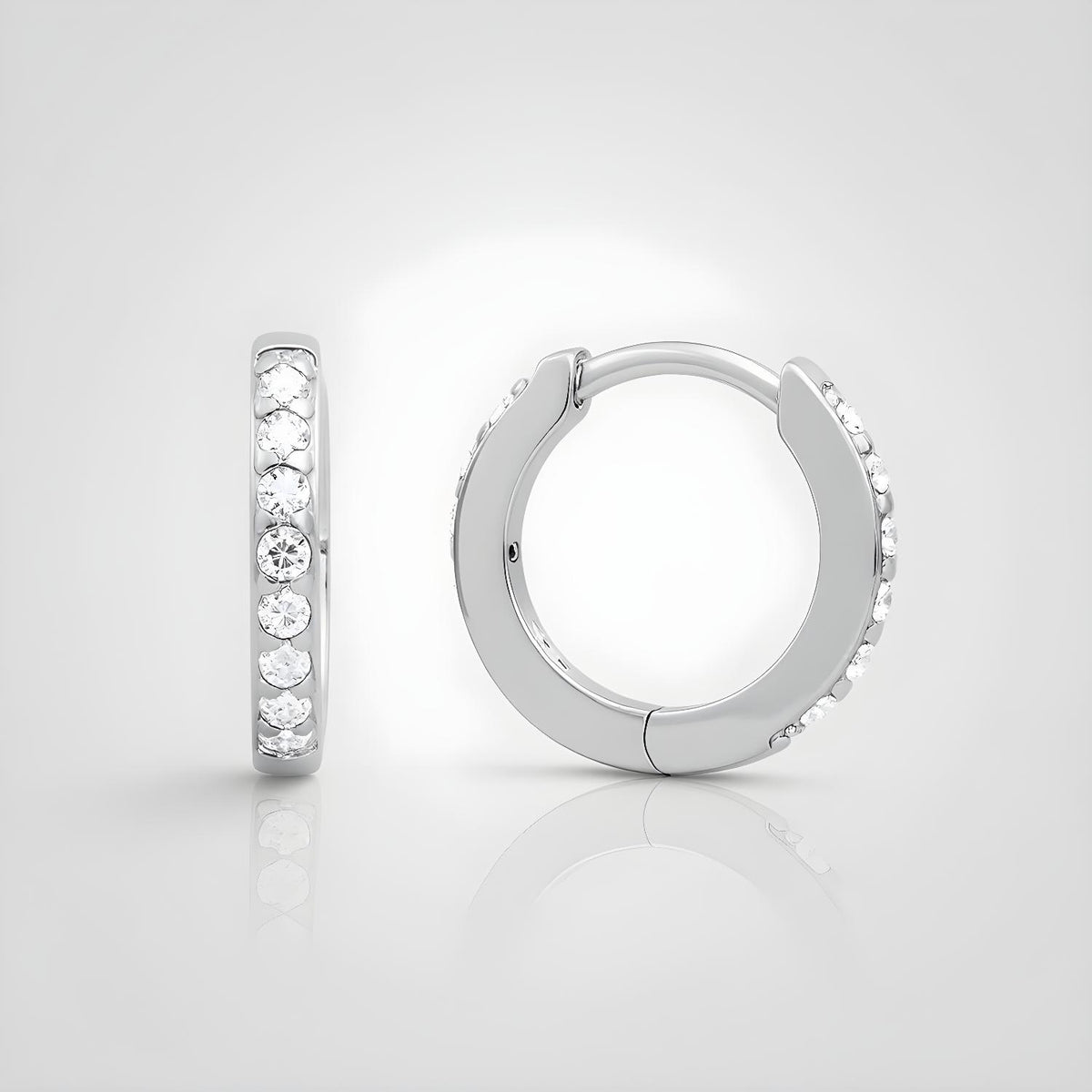 Sterling silver huggie hoop earrings with channel-set cubic zirconia, shown against a white background.