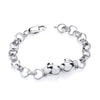 A Silversmiths sterling silver child’s boxing glove bracelet with two charms, shown on a white background.