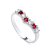 Sterling silver wishbone ring with alternating simulated ruby-red and clear cubic zirconia stones.