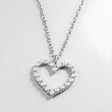 Sterling silver heart necklace by Silversmiths features cubic zirconia stones on a fine, delicate chain.