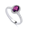 Sterling silver ring with a simulated amethyst center, cubic zirconia halo, and accent stones.