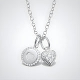 Sterling silver necklace featuring a cubic zirconia heart charm with halo and gem accents.