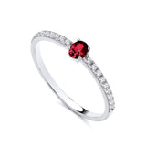 Sterling silver ring by Silversmiths featuring a simulated ruby center and cubic zirconia accents.