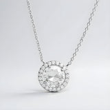 Silversmiths sterling silver necklace with a cubic zirconia center stone and a halo of small sparkling accents.