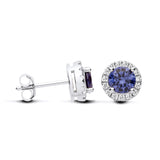 Sterling silver stud earrings feature simulated tanzanite blue stones surrounded by CZ halos in a silver setting.