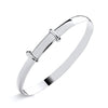 A sterling silver expanding baby bangle with a D-shaped profile is displayed against a white background.