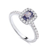 Sterling silver ring featuring a simulated tanzanite center and a cubic zirconia halo on a polished band.