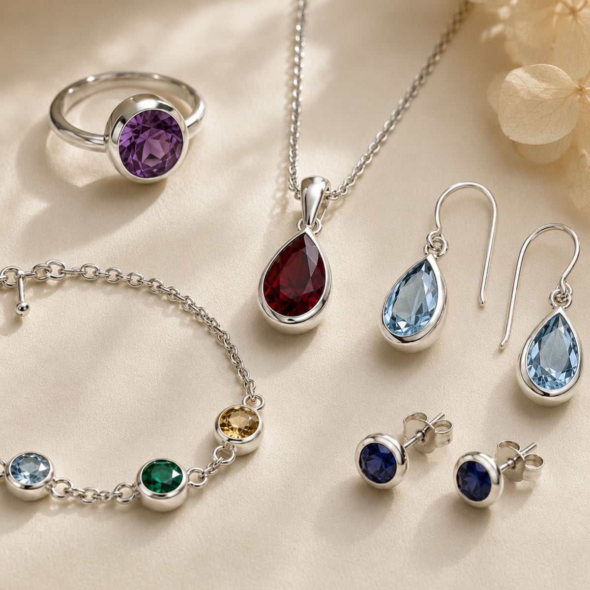 A silver jewelry set with colorful gemstones includes a ring, bracelet, necklace, earrings, and studs.